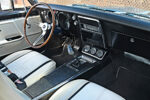 014 Classic car interior with a wooden steering wheel and white seats 1967 camaro