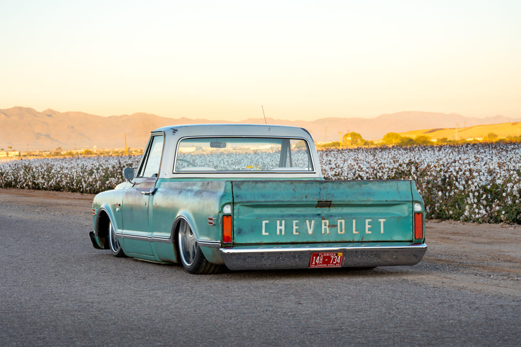 05 Rear view of a 1968 Chevrolet C10 teal at twilight