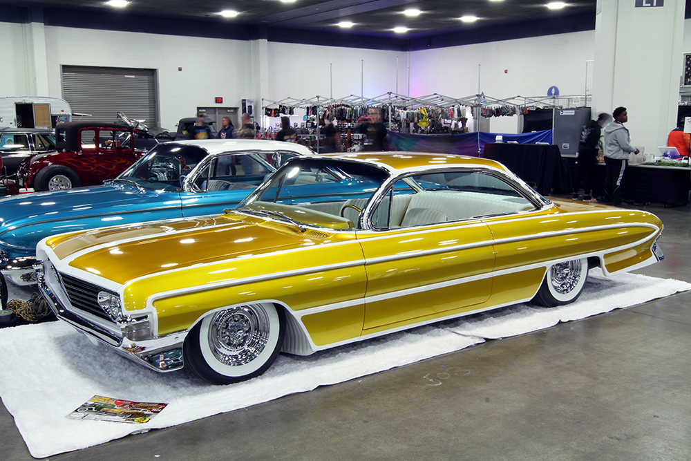 16 yellow 1961 olds 88 trophy winner on display at the detroit autorama