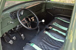 12 Interior view of 1954 Ford F100 with black leather seats and green belts