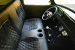 14 Custom black interior and dashboard of 1954 Ford F100 with quilted seats