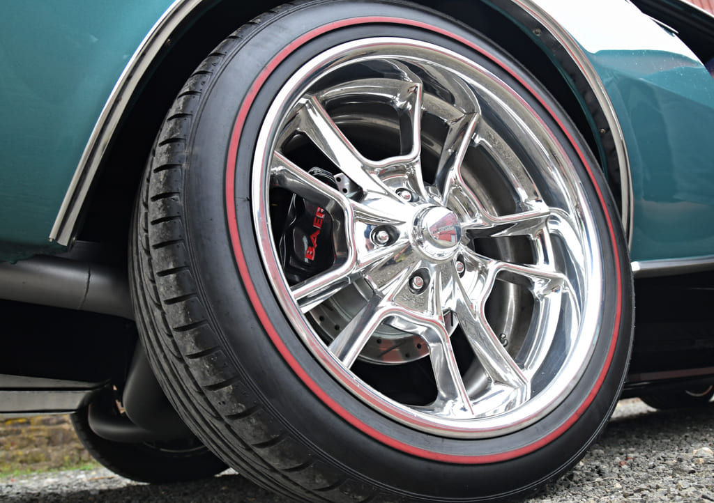 023 Close up of a chrome wheel with red line tires and BAER brake caliper