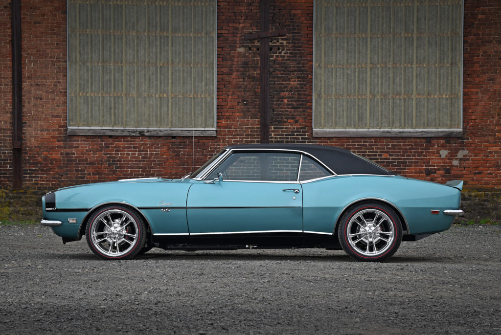 007 Side profile of a teal 1968 Camaro SS with black vinyl top and chrome wheels
