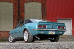 006 Rear view of a teal 1968 Camaro SS with a black roof showcasing tail lights