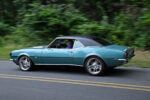 021 Motion shot of a teal 1968 Camaro SS with a black top on the road