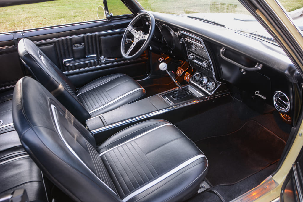 011 Interior view of the 1967 Camaro featuring black seats and dashboard