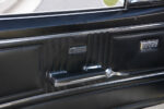 026 Camaro's interior door panel with the logo and window crank