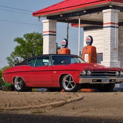 003 Red 1969 Chevelle SS parked at an old gas station daylight