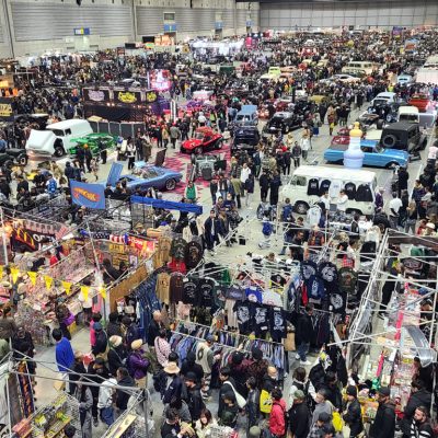 05 Overview of a crowded event hall at Yokohama Hot Rod Custom Show with various classic trucks and vendor booths