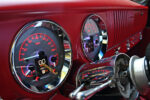 10 Close up of a 1954 Chevy truck's red dashboard with custom gauges