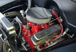 14 Detailed view of a 1954 Chevy truck's engine with red accents and chrome air filter